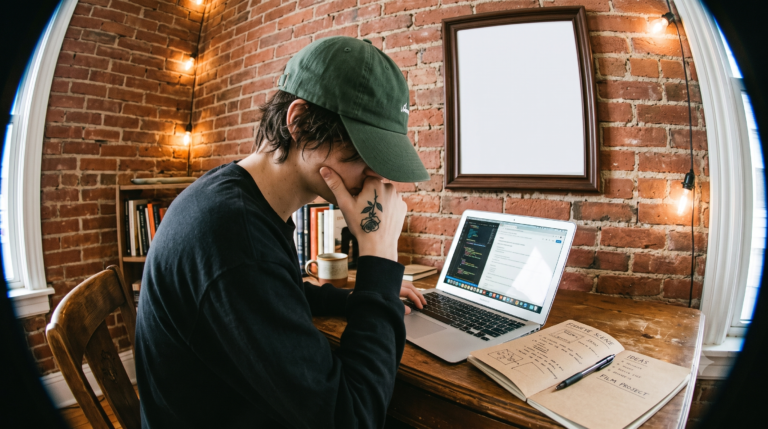 young man frustrated while working on laptop